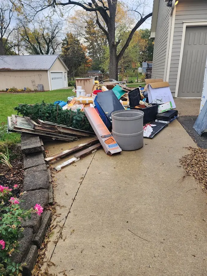 Dumpster being loaded with debris for Estate Cleanout Dumpster Rental in Massac